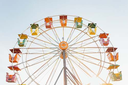 ferris wheel worm's eye view of red, orange, and yellow Ferris wheel amusement park